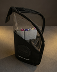 Angled view of the Knightshift black zipper pouch with assorted markers against a charcoal-and-gold background.